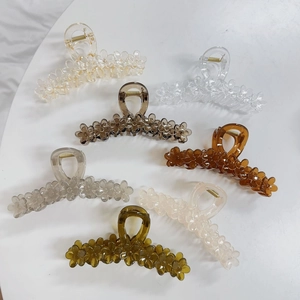 Flat lay of six large jelly-colored flower hair claws in multiple assorted colors