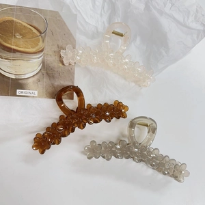 Floral hair claw clips in cream, translucent brown and grey with resin flower design