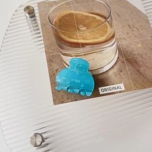 Macro shot of light blue V-305 model matte hair clip on minimalist postcard props