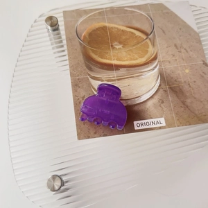 Close-up of a purple translucent matte hair claw clip with R-305 engraving on acrylic