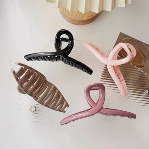 Set of four large matte hair claw clips in black pink brown and purple colors