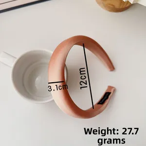 Detail view of 3.1cm wide satin padded headband with handmade label and product dimensions