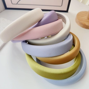 Macro detail of thick padded sponge headbands in a variety of soft macaron colors