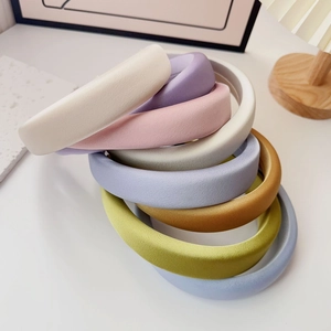 Close-up of colorful thick sponge headbands in eight soft pastel fabric textures