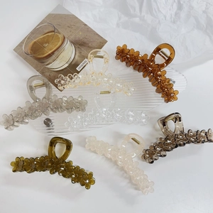 Detailed set of six jelly colored floral hair claws in amber cream and green colors