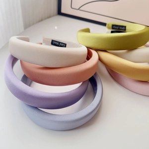 Close-up of padded sponge headbands in macaron colors with handmade label detail