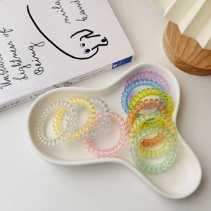 Multicolor spiral hair ties in cloud tray with a lifestyle minimalist aesthetic