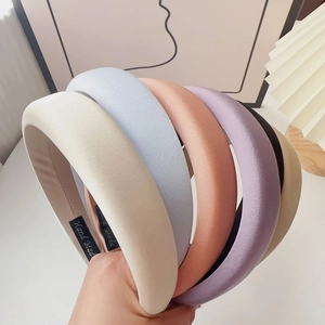 Detail showing the thick sponge padded headbands with various colors and handmade label