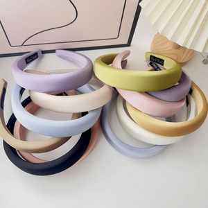 Close-up of colorful thick sponge headbands with a handmade woven label detail