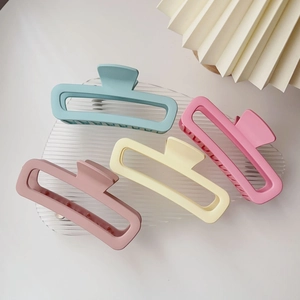 Grandi mollette per capelli opache in colori pastello su un vassoio di vetro