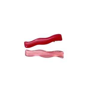 Set of two wavy hair clips in solid dark red and translucent pink acrylic resin