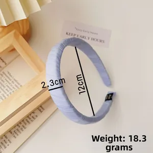 Detail of light blue fabric headband showing 2.3cm width and 12cm diameter dimensions