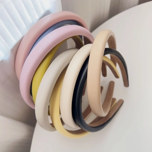 Detailed stack of multi-colored padded PU leather headbands with matte finish texture