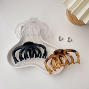 Three large tortoiseshell and matte octopus hair claws for thick hair on white tray