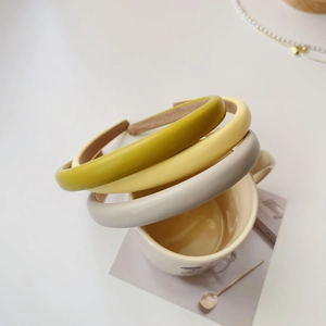 Chic padded faux leather headbands in pastel green, yellow, and beige for volume