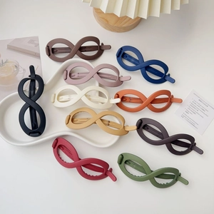Matte infinity hair clips in ten colors set on a wavy white tray with ins style decor