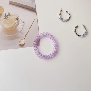 Purple spiral hair tie with silver sparkling rhinestone C-shaped hoop earrings