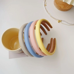 Macro detail of high crown sponge headbands in four candy colors with anti-slip lining