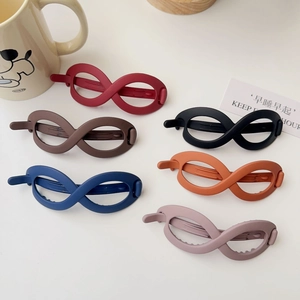 Detail view of infinity-shaped matte hair clips in six elegant Morandi colors