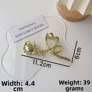 Detailed view of gold metal rose hair claw clip with dimensions 11.2cm x 6cm and 39g weight
