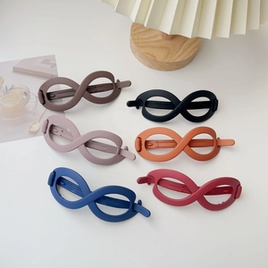 Detail of matte infinity hair clips in six colors on a stylish white background