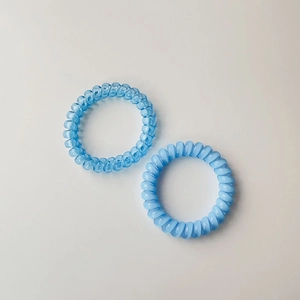 Two-pack of translucent blue spiral hair ties with durable elastic phone cord design