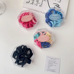 Macro shot of high elasticity towel hair rings in a transparent hexagonal gift box