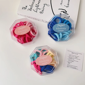 Close-up of colorful high-elasticity hair ties in hexagonal gift boxes for kids