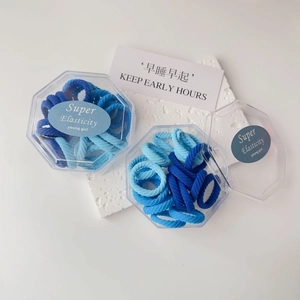 Blue shades high elasticity hair ties set in hexagonal storage boxes with clean aesthetic
