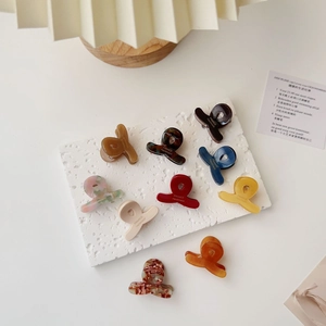 Collection of ten mini acetate hair claws in various colors and marble patterns