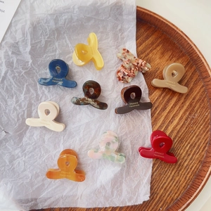 Detailed close-up of colorful mini acetate hair claws with France Handmade engraving