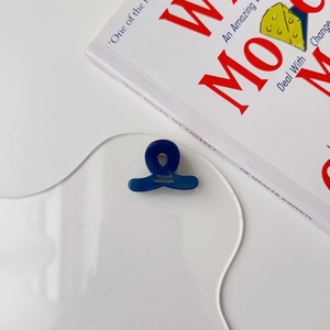 Detailed macro view of dark blue acetate hair clip with gold France Handmade lettering
