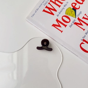 Detailed shot of dark brown mini cellulose acetate hair claw with France Handmade logo