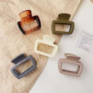 Minimalist square claw clips in amber, green, white, gray and pink resin on paper