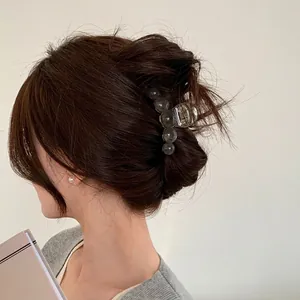 Translucent amber-textured grey hair claw clip for women styled on a model's head