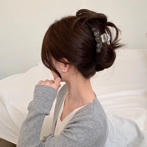 Elegant amber-textured beaded hair claw clip for thin hair shown on a female bun
