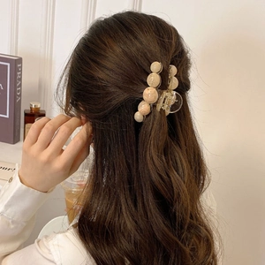 Amber texture marble bead hair claw clip for women shown on long wavy brown hair