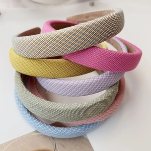 Close-up of assorted padded sponge headbands in solid colors and woven fabric textures
