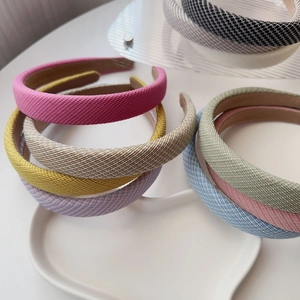 Macro detail of thick woven sponge headbands in pastel colors with anti-slip inner lining