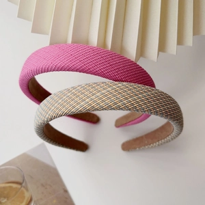 Detail of padded sponge headbands showing magenta woven fabric and plaid pattern texture