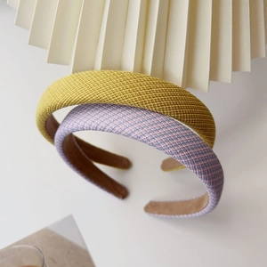 Close-up of ginger yellow and purple-pink woven sponge headbands with non-slip lining