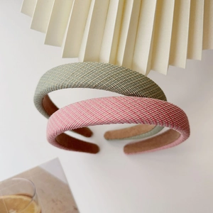 Detail of woven fabric sponge headbands in pink and grey tones with non-slip lining