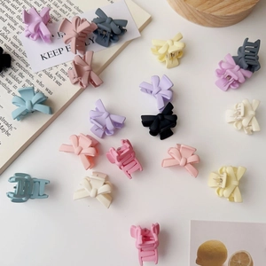 Close-up of matte butterfly mini hair claws in assorted macaron colors for women