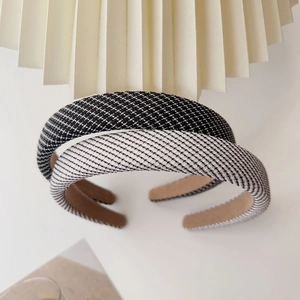 Detail of tweed fabric texture on wide padded headband set in grey and black