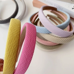 Detailed view of colorful twill woven sponge headbands with various textures and colors