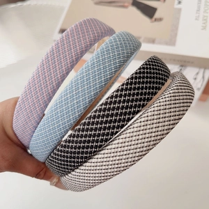 Detailed close-up of thick sponge headbands with various checkered fabric patterns