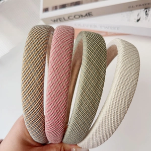Thick padded fabric headbands in striped and textured colors for a high-volume look