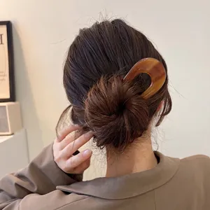 Minimalist acetate U-shaped hair pin in tortoiseshell color for elegant bun hairstyles