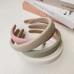 Close-up of thick sponge headbands with woven texture in soft pastel color options