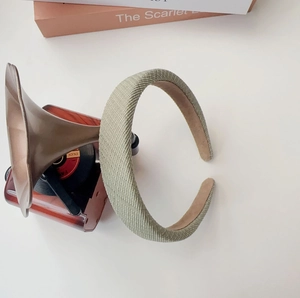Detail of light green woven sponge headband featuring thick retro padded design